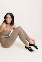 Load image into Gallery viewer, Black Shashi grip socks worn during Pilates and functional studio workout
