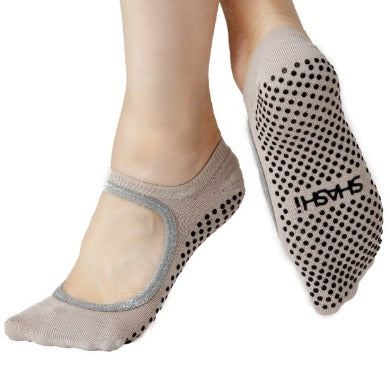 grip socks with grips and a large opening on the upper part of the foot in taupe color with silver trim